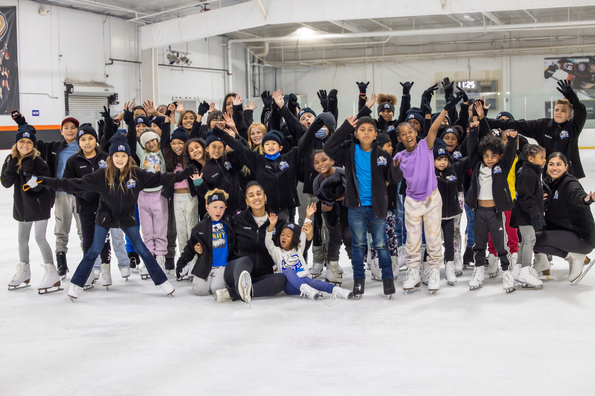 Unity Ice Academy skaters, coaches, and families gathered on the ice.